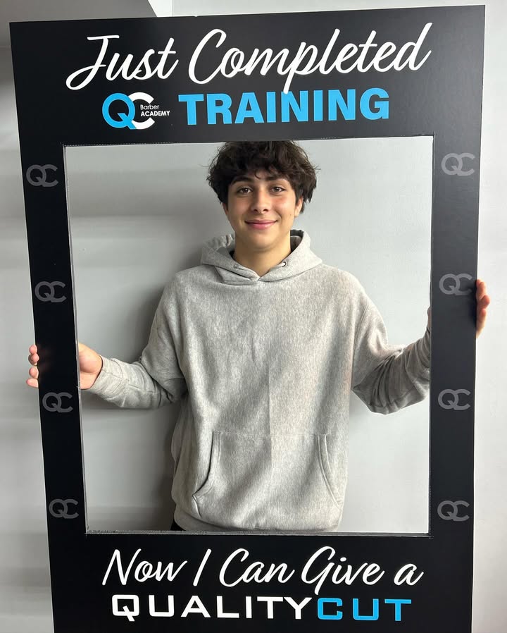 Student holding framed certificate