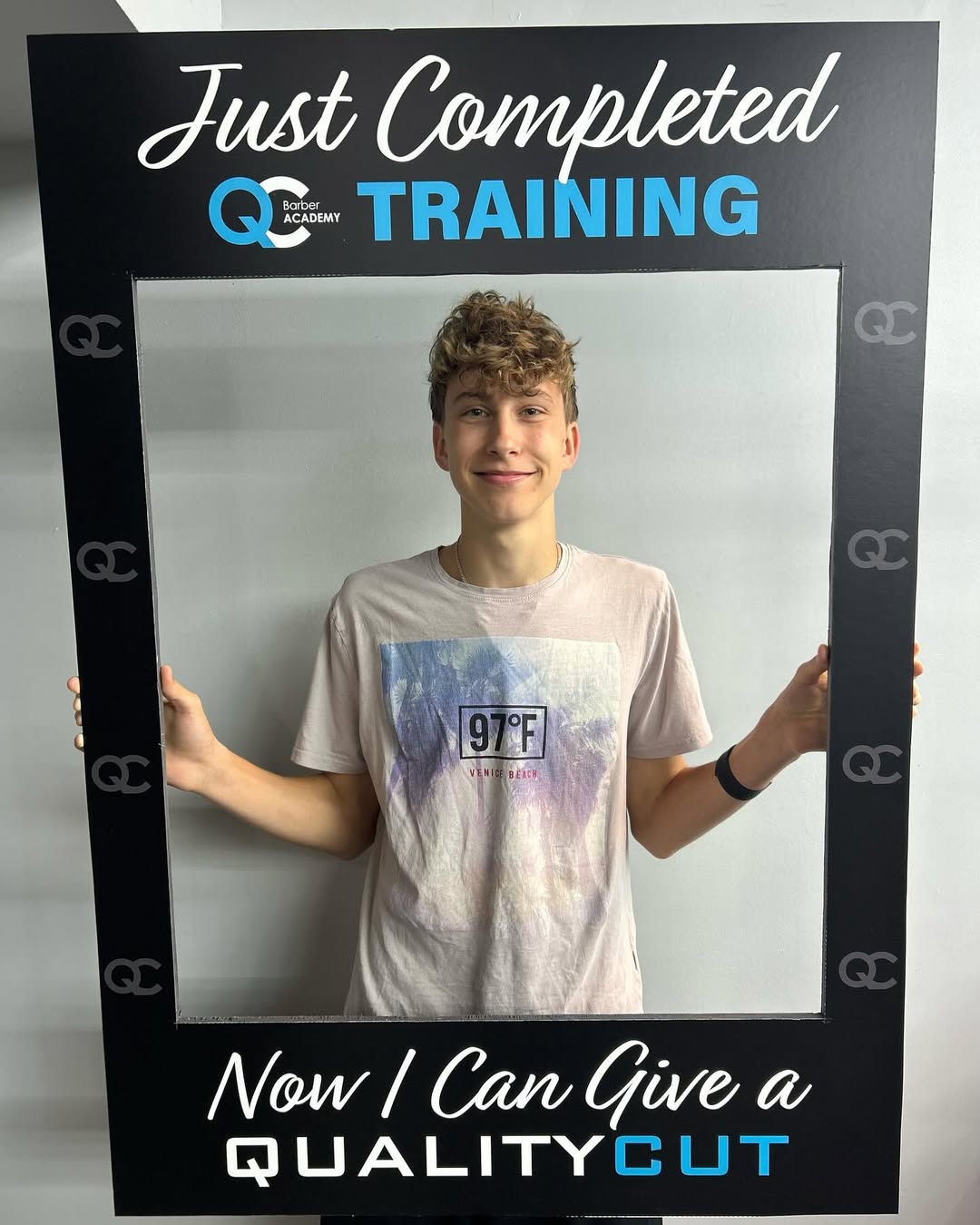 Graduate holding framed photo